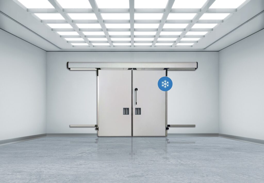 Sterile room with double sliding cold-room doors and grid lights.