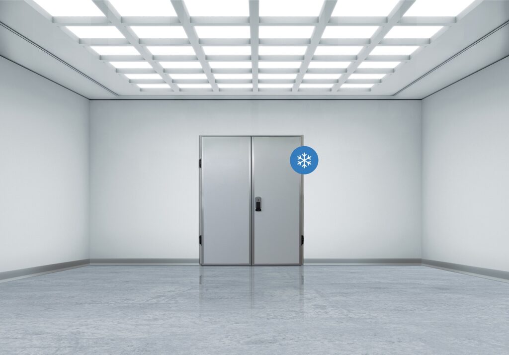 Sterile room with bright grid ceiling and double metal freezer doors.