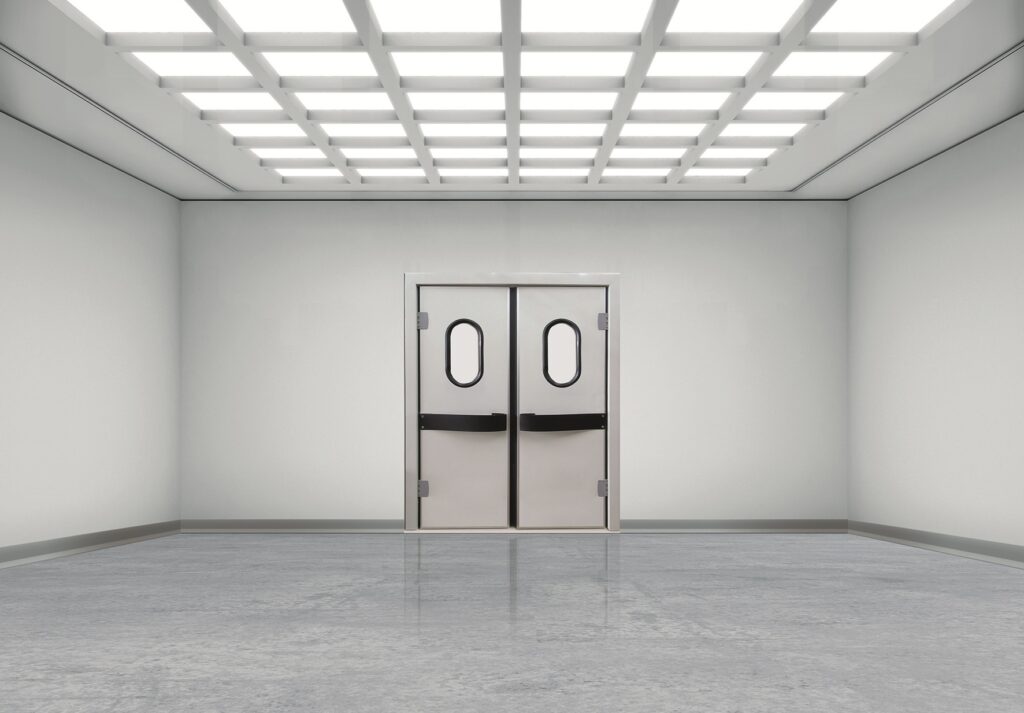 Empty white room with double swing doors and bright grid lights