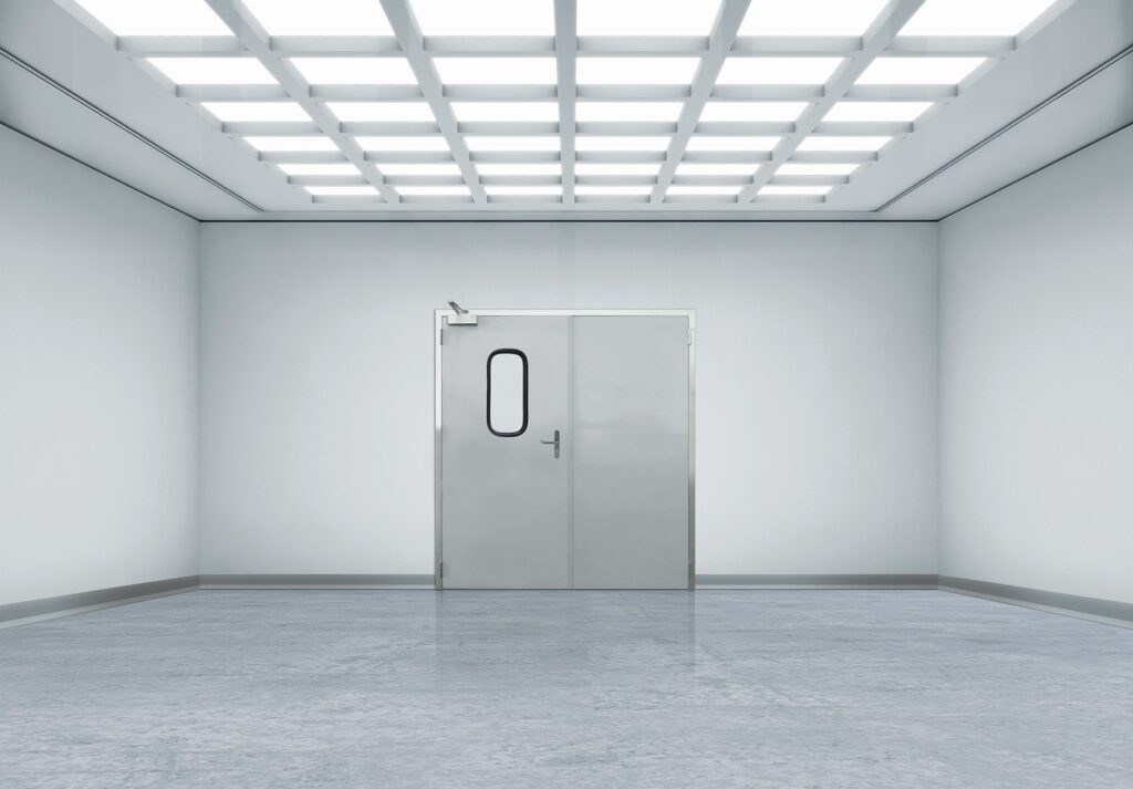 Sterile white room with metal double doors and grid ceiling lights