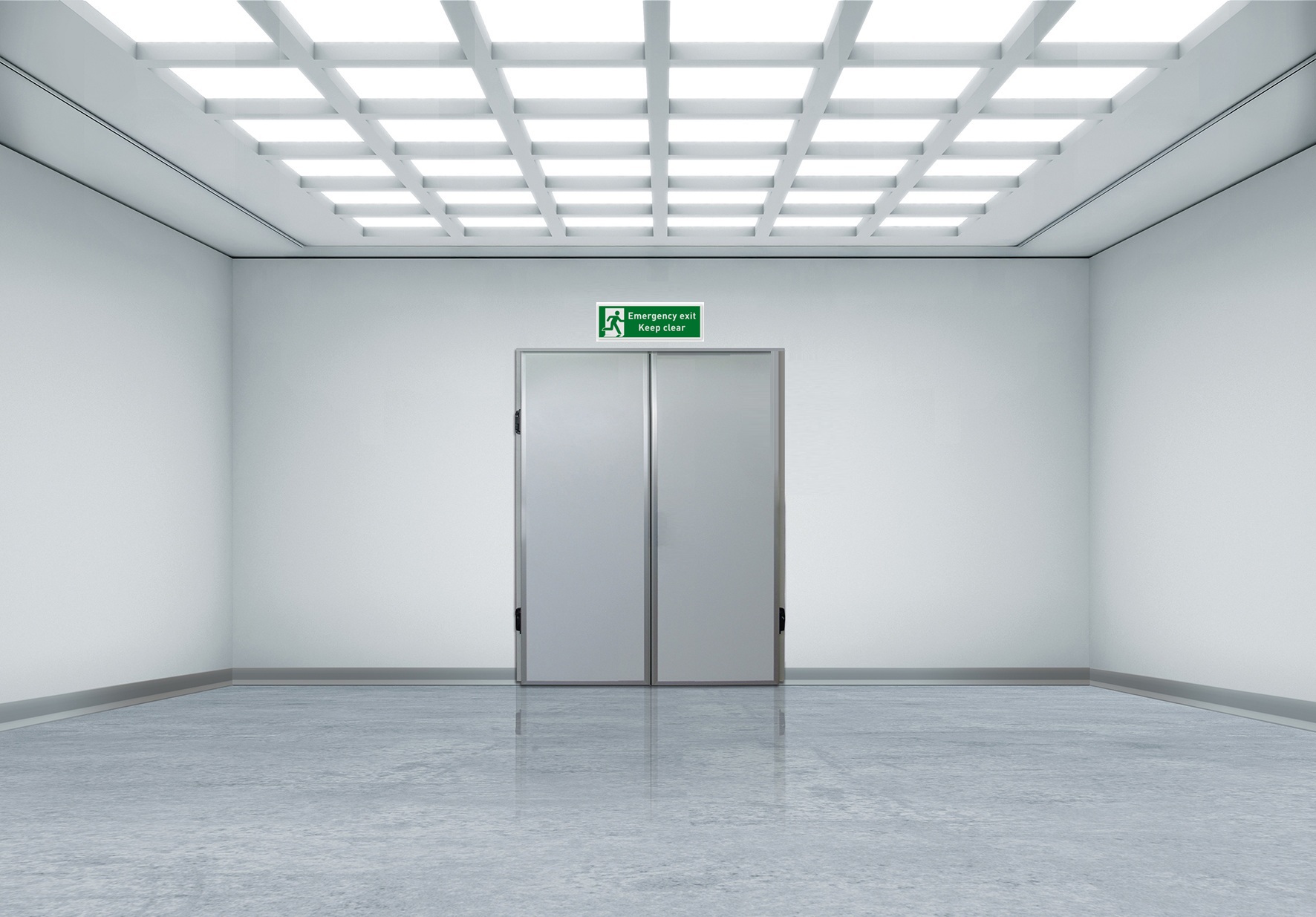 Bright empty corridor with double doors and a green emergency exit sign.